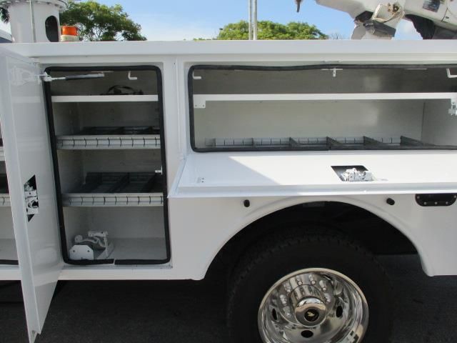 A white utility truck with the doors open