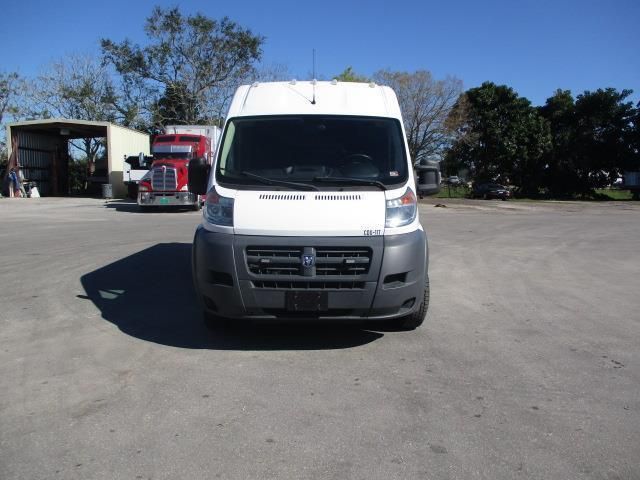 A white dodge van is parked in a parking lot