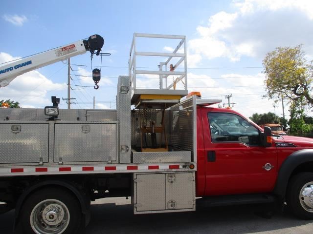 A red truck with a crane on top of it
