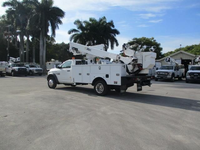 A white utility truck is parked in a parking lot
