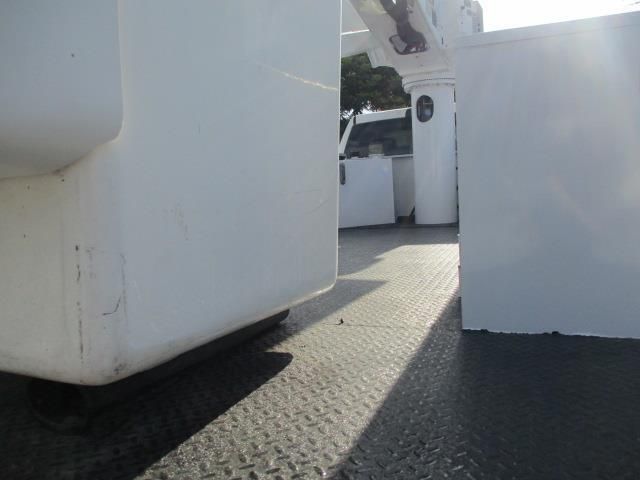 A white container is sitting on top of a metal floor.