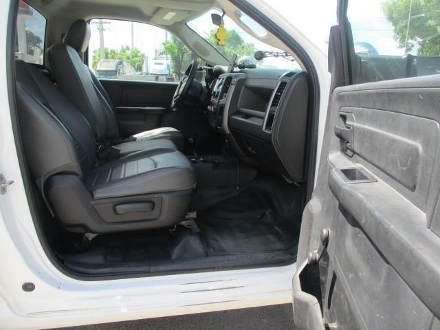 The inside of a white truck with black seats