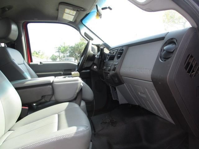 The interior of a red truck with grey seats