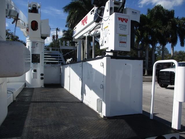 A white utility truck with a crane on top of it