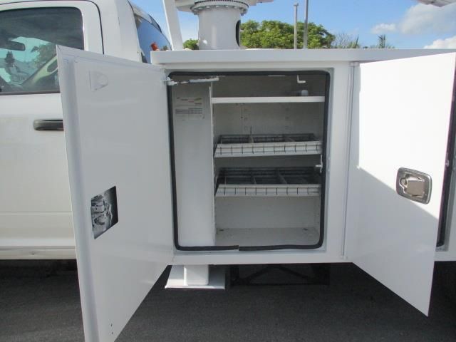 A white truck with the doors open and a cabinet inside