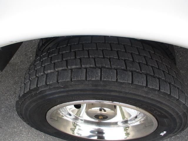 A close up of a tire on a white car