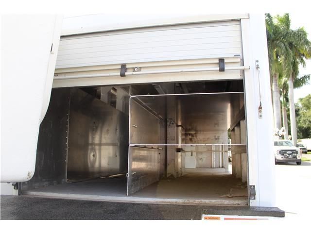 The inside of a white truck with the door open