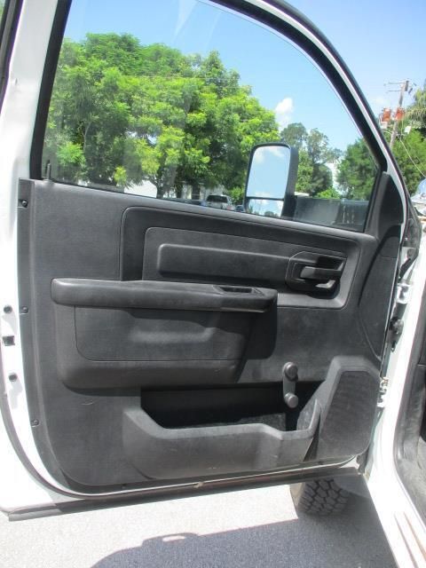 A white dodge ram with the door open