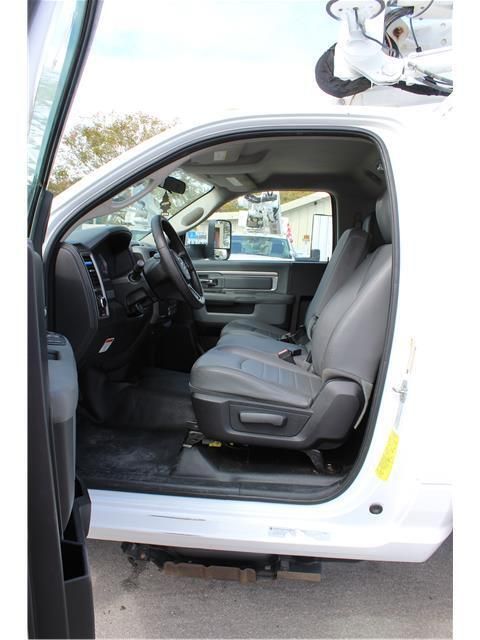 The inside of a white truck with the door open
