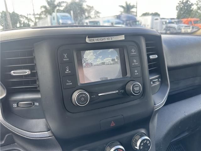 A car dashboard with a rear view camera and a radio.