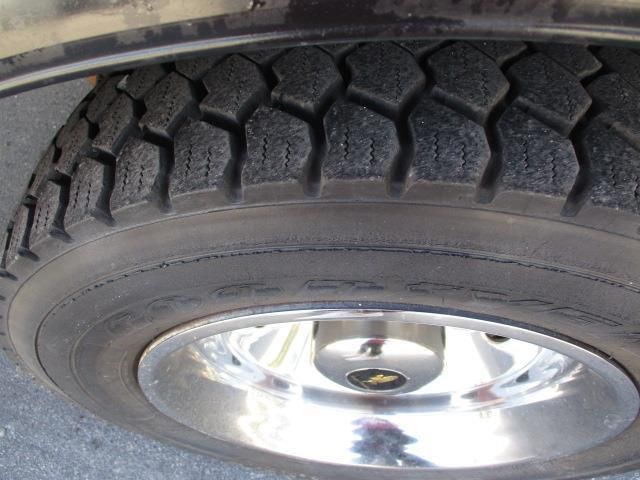A close up of a tire with a chrome rim