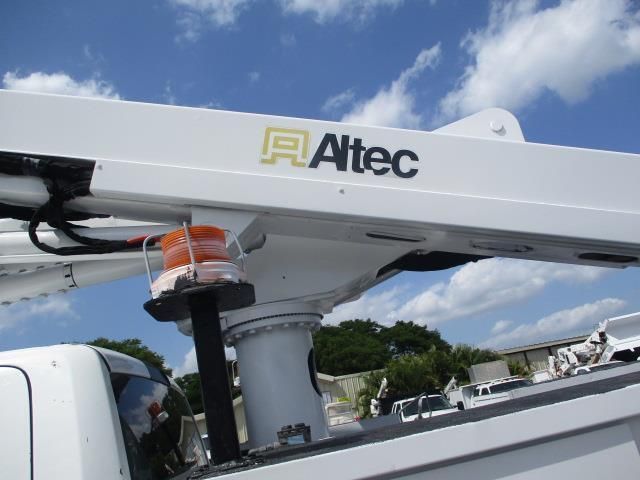 A white truck with an altec logo on the side