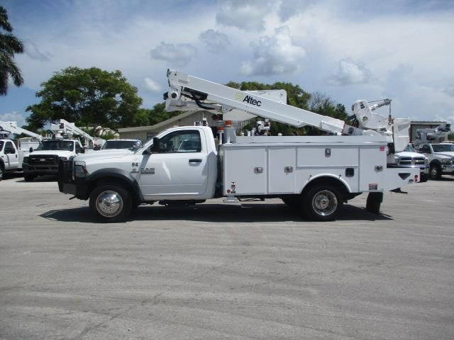 A white utility truck is parked in a parking lot