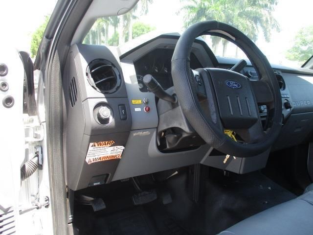 The interior of a ford truck with the door open