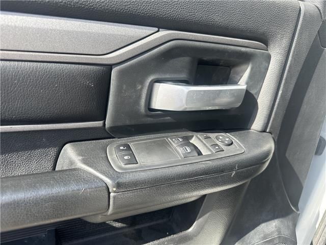 A close up of a door handle on a white ram truck.
