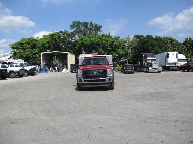 A red ford truck is parked in a parking lot