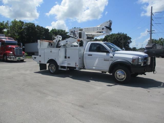 A white utility truck is parked in a parking lot