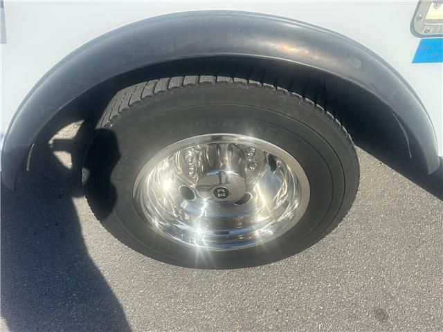 A close up of a tire on a white truck