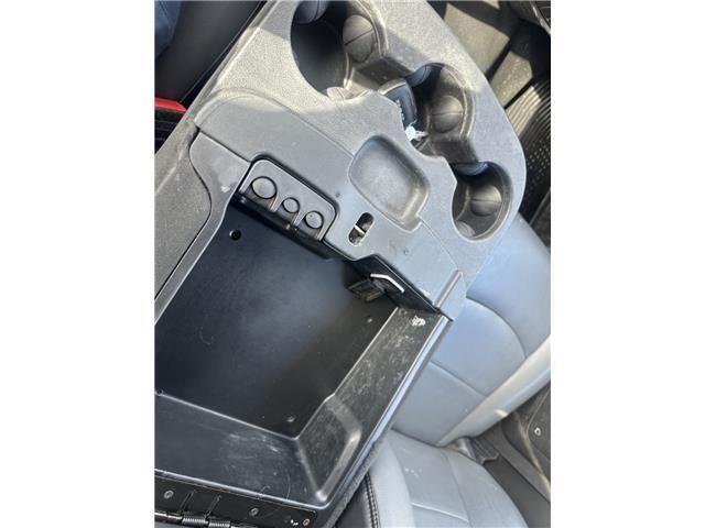 A close up of a car console with a cup holder