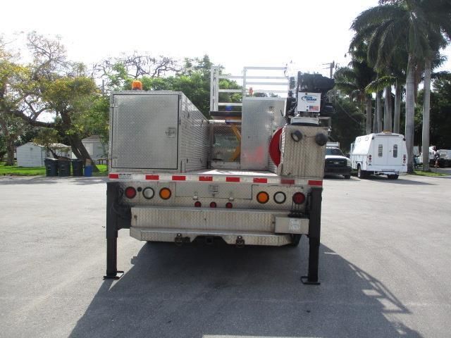 A silver truck is parked in a parking lot