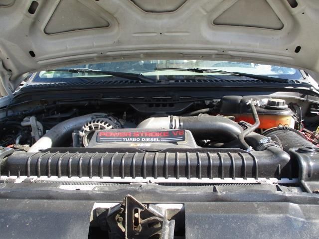 The engine of a ford truck is shown with the hood open