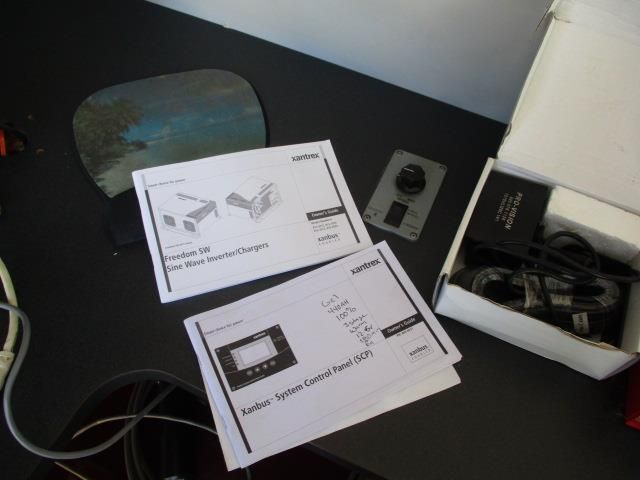 A couple of papers on a desk with one that says ' charger ' on it