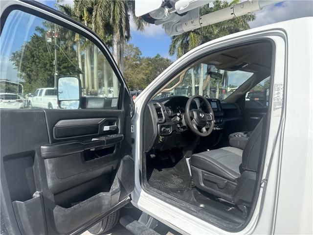 The inside of a white truck with the door open.