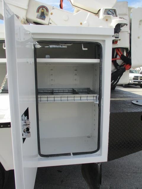 A white cabinet with a glass door and shelves