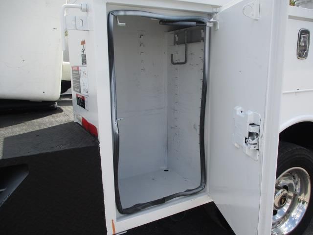 A white utility truck with the door open