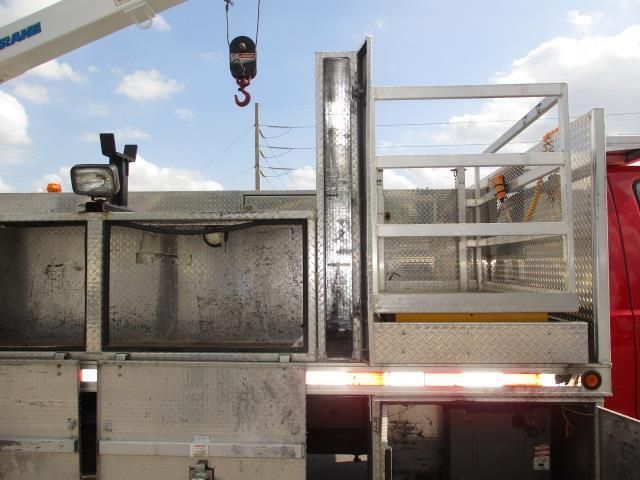 A crane is hanging from the side of a truck