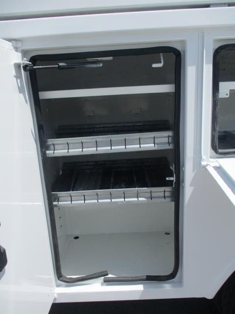The inside of a white truck with the door open