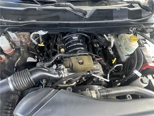 A close up of a car engine with the hood open