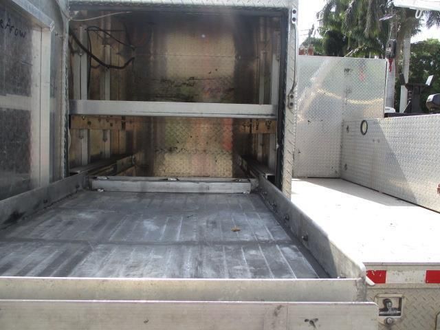 The back of a stainless steel truck with the door open