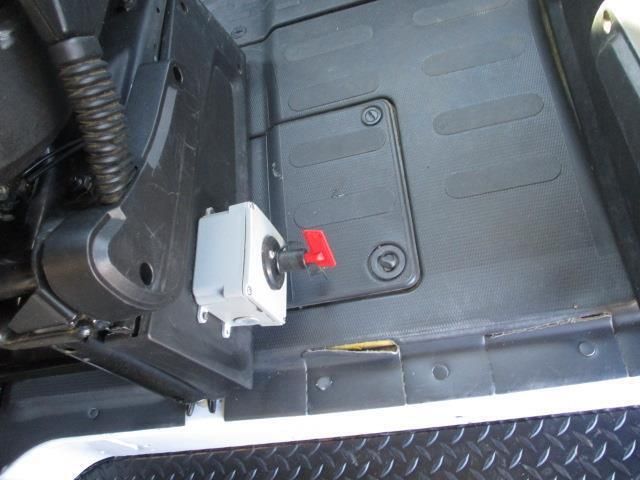 A close up of a switch on the floor of a vehicle
