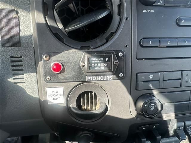 A car dashboard with a clock that says 2 to hours