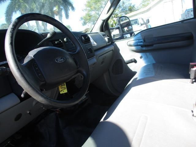The steering wheel of a ford truck has a yellow tag on it