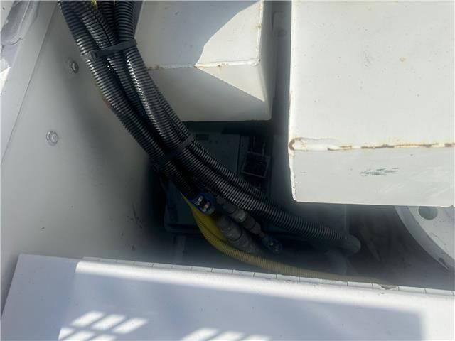 A white box with a bunch of wires coming out of it