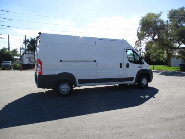 A white van is parked on the side of the road