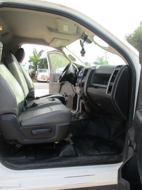The inside of a white car with the door open