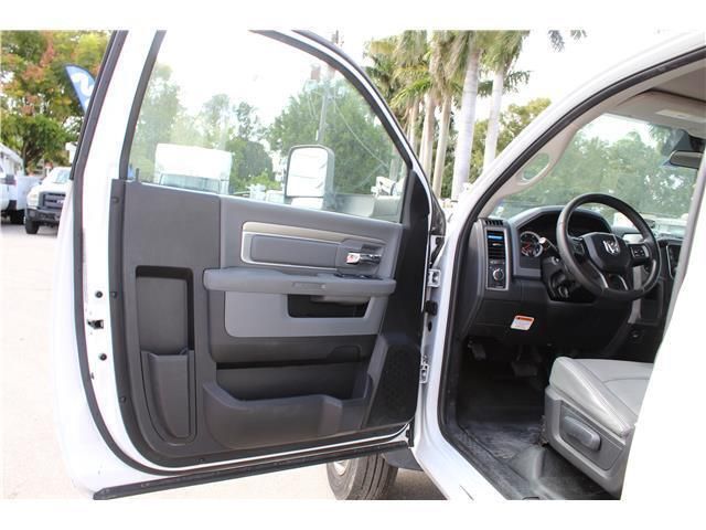 A white dodge ram truck with its doors open