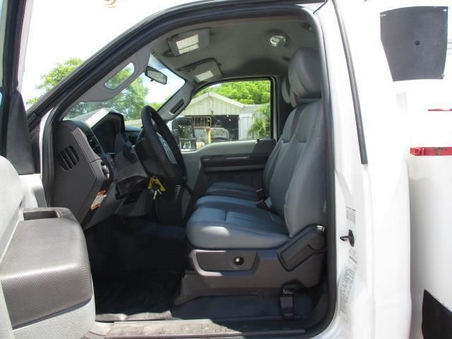 The inside of a white truck with the door open