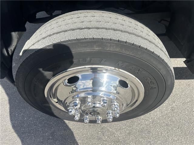 A close up of a truck tire with a chrome rim