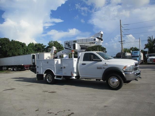 A white utility truck is parked in a parking lot