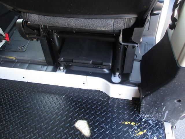 A black diamond plated floor with a seat in the background