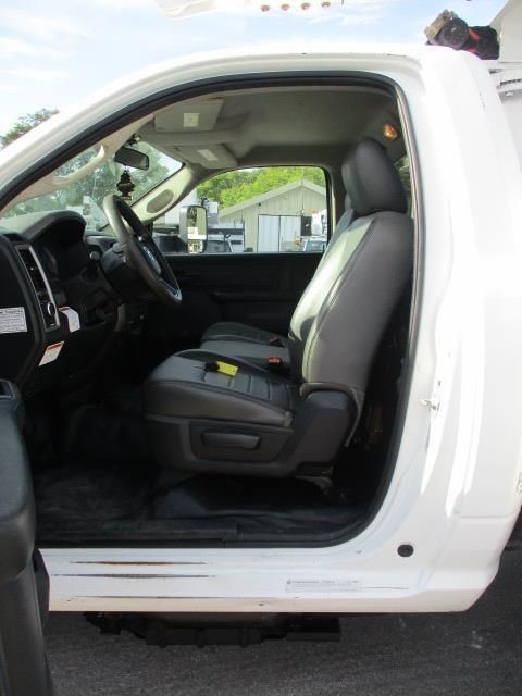 The inside of a white truck with the door open