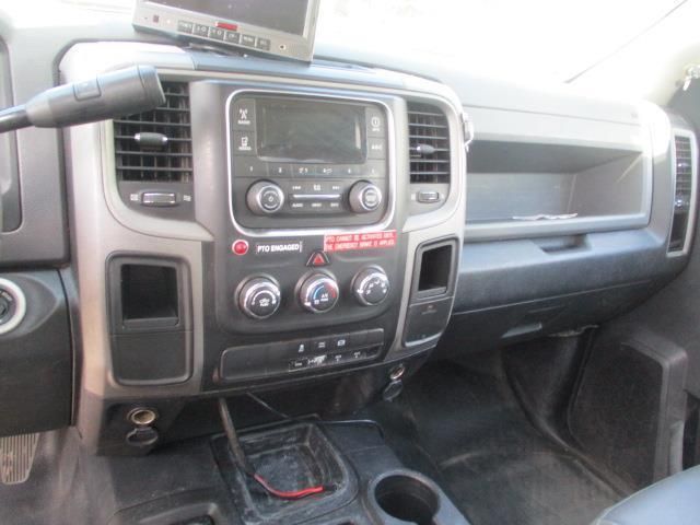 The interior of a dodge ram truck with a radio and a microphone.