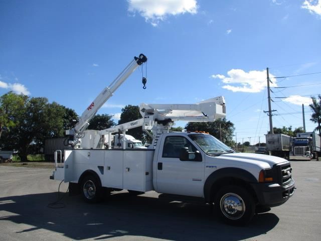 A white truck with a crane attached to it