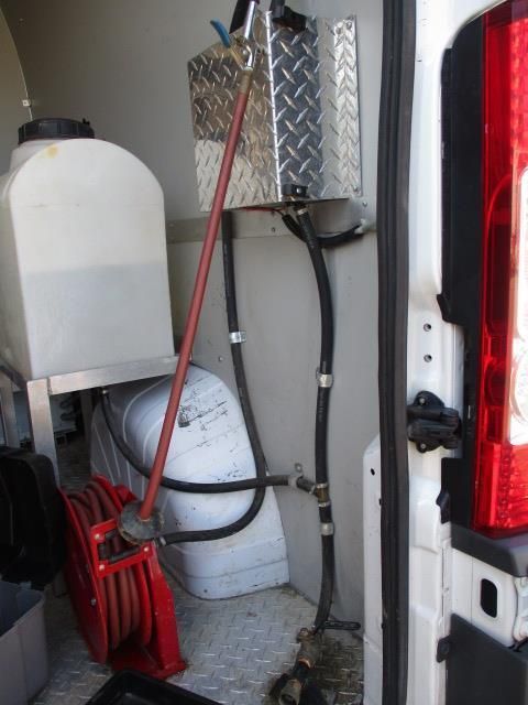 The back of a white van with a red tail light