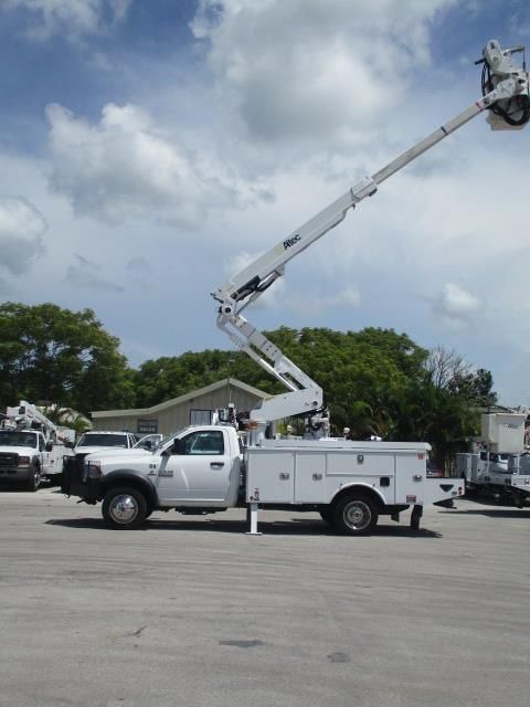 A white utility truck is parked in a parking lot