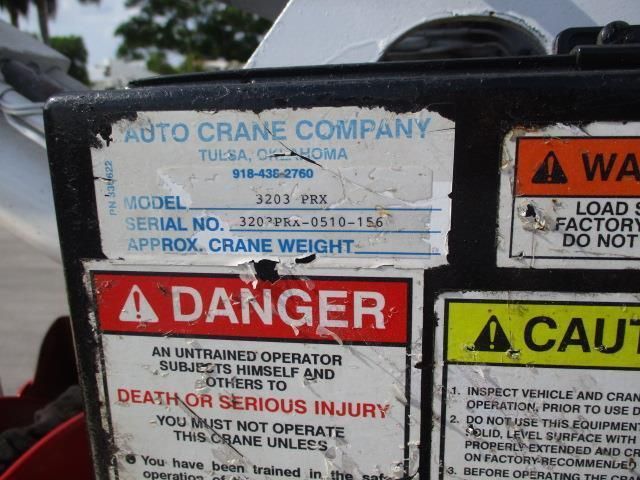 An auto crane company sign that says danger on it